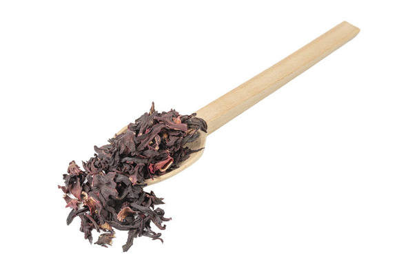 Dry hibiscus tea on wooden spoon isolated on white background. herb. herbal tea. food ingredient. - Fotó, kép