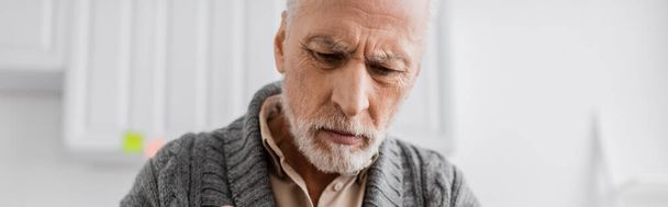 depressed grey haired man with alzheimer syndrome looking down at home, banner - Foto, Imagen