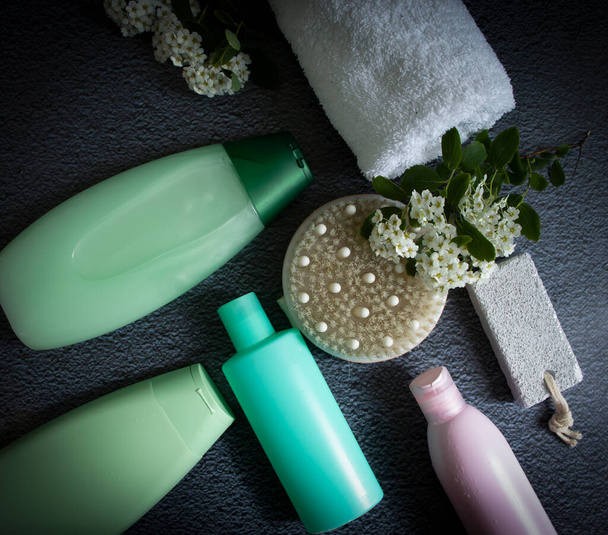 Cosmetic cream, flower, massage brush on old background - Foto, afbeelding