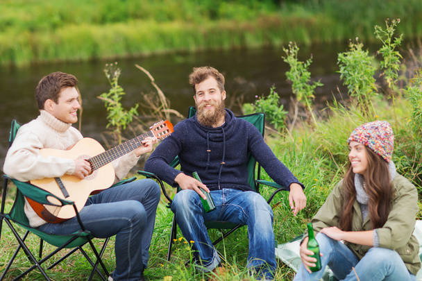 group of tourists playing guitar in camping - Foto, Imagen