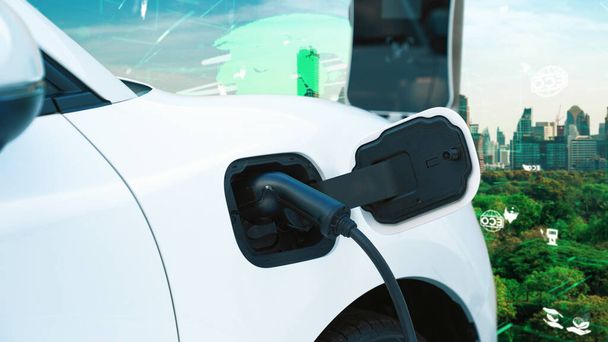 Progresivní zelené město ESG symbol pozadí s elektrickým vozidlem, EV auto dobíjení energie na dobíjecím stanovišti pro zvýšení povědomí o životním prostředí s obnovitelné energie poháněné dopravy. - Fotografie, Obrázek