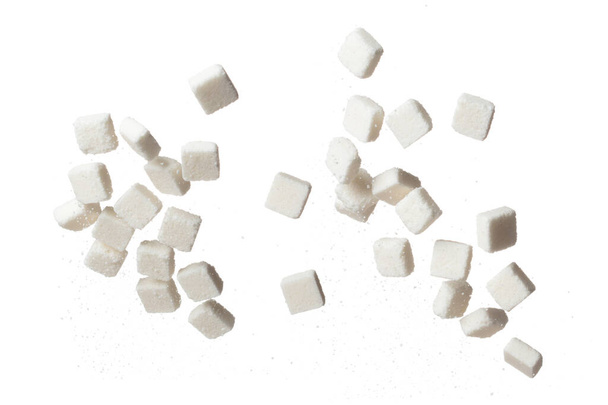 Pure Refined Sugar cube flying explosion, white crystal sugar abstract cloud fly. Pure refined sugar cubes splash stop in air, food object design. white background isolated high speed freeze motion - Foto, Imagen