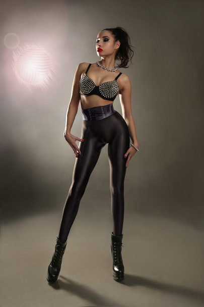 Woman in bra with spikes and leggins - Φωτογραφία, εικόνα