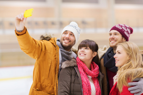 happy friends taking selfie on skating rink - Fotografie, Obrázek