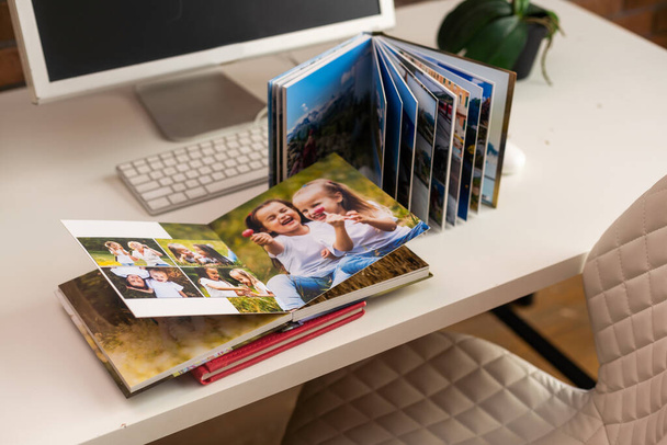 Family photos archive saved in brightly designed photo book, bright summer memories placed in the photobook. - Foto, Imagem