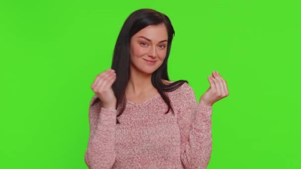 Cheerful rich millennial woman showing wasting or throwing money around hand gesture, more tips dreaming about big profit body language. Young millionaire girl isolated on green chroma key background - Filmagem, Vídeo