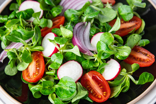 fresh salad tomato, radish, onion, mache lettuce, green leaves vegetable snack healthy meal food on the table copy space food background rustic top view - Photo, Image