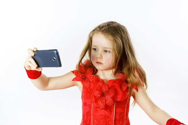 Cute  little ballerina dressed in red  taking a selfie photo - Foto, Imagen