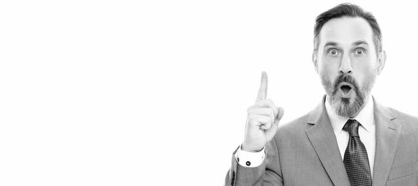 Man face portrait, banner with copy space. shocked businessman showing smartphone isolated on white. man in suit raised finger - Foto, Bild