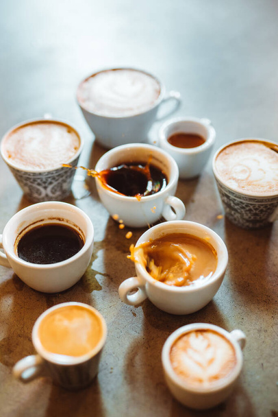 Vertical view of the many cups of coffee standing on stone table. Different types of hot beverage. Flat lay with copy space - Photo, Image