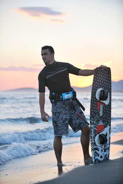 Portrait of a young kitsurf man at beach on sunset - Valokuva, kuva