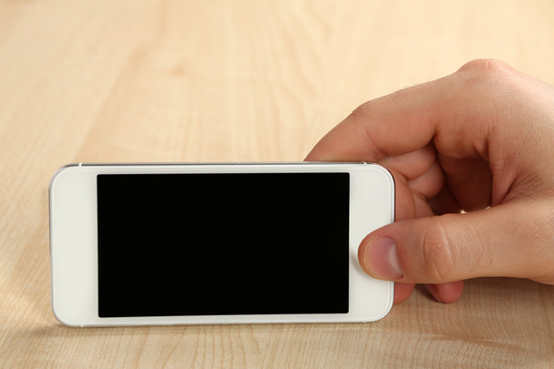 Hand holding mobile smart phone - Фото, зображення
