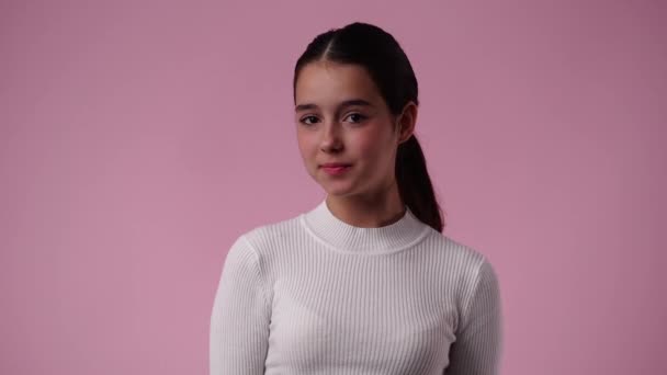 4k slow motion video of one girl blinking at the camera on pink background. Concept of emotions. - Séquence, vidéo