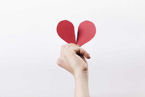 Woman hand holding broken paper heart - Foto, imagen