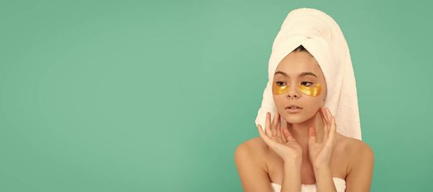 Girl with healthy skin, facial treatment, teen girl in shower towel with eye patch. Cosmetics and skin care for teenager child, poster design. Beauty kid girl banner with copy space - Photo, Image