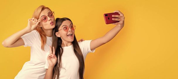 Mother and daughter child banner, copy space, isolated background. .selfie family. modern life. mobile technology. having video call. mother and daughter vlogging - 写真・画像