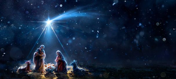 彗星の星とイエスの降誕-雪の夜と星空の聖家族とのシーン-アブストラクト焦点を当てた背景 - 写真・画像