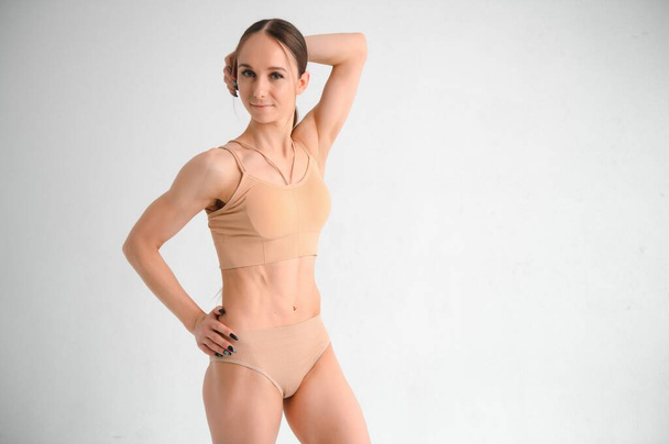 Beautiful woman with slim body in underwear is in the studio - Fotó, kép