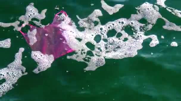 Мусорный пластиковый пакет на море бьет волной, экологией - Кадры, видео