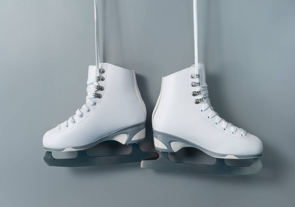 Pair of white figure ice skates shoes on blank gray background - Foto, Imagen