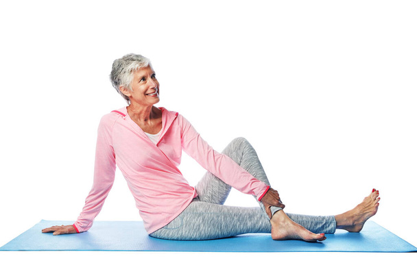 Stretching legs, yoga and senior woman in studio isolated on a white background mock up. Zen chakra, pilates fitness and retired female model sitting, thinking and training for health and wellness - Fotoğraf, Görsel