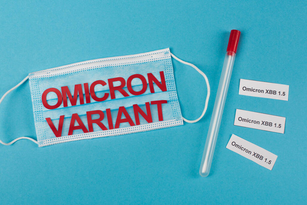 Top view of medical mask and throat swab near omicron xbb lettering on blue background - Fotoğraf, Görsel