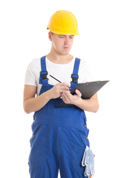 man builder in blue uniform and helmet writing something in clip - 写真・画像