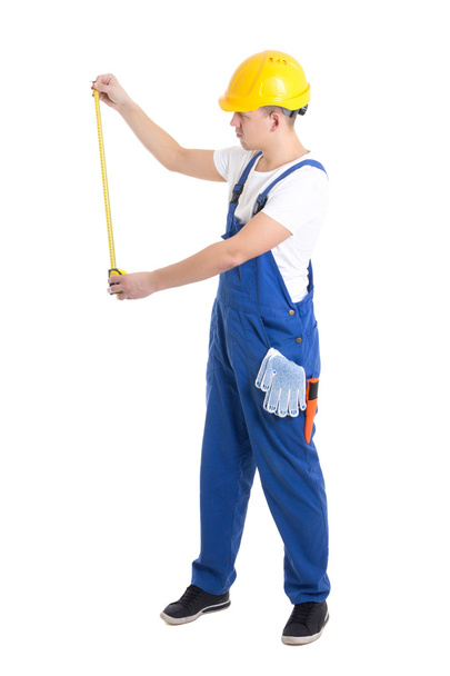 ölçü birimi teyp tutan mavi tulumlu adam Builder'da yan görünüm  - Fotoğraf, Görsel