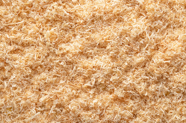 Wood flour, wood powder, surface of fine sawdust, formed by sawing dried spruce. Finely pulverized wood, a by-product and waste product, mainly used as a filler and extender. From above, macro photo. - Fotoğraf, Görsel