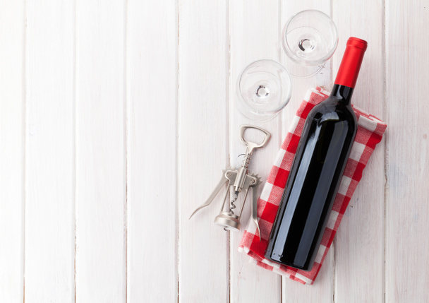 Red wine bottle, glasses and corkscrew - Photo, Image