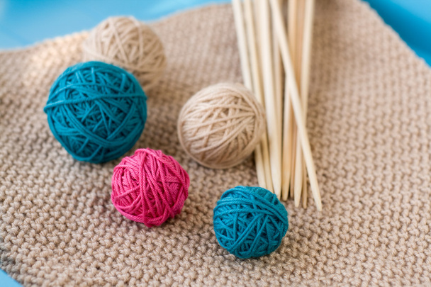 Colorful balls and wooden needles lying on beige  - Photo, Image