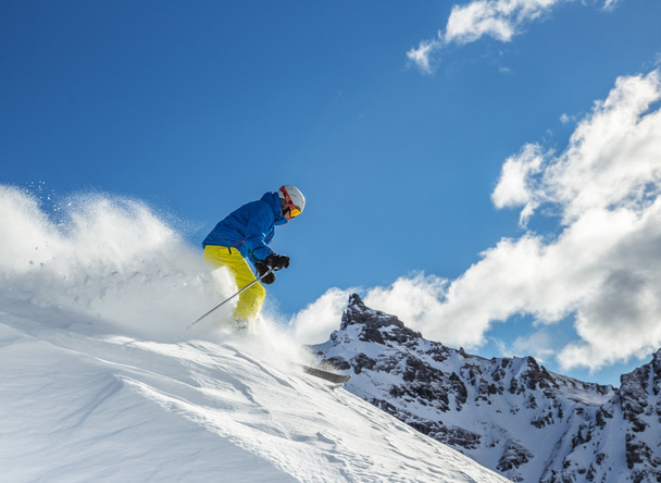 Skier skiing downhill in high mountains - Φωτογραφία, εικόνα