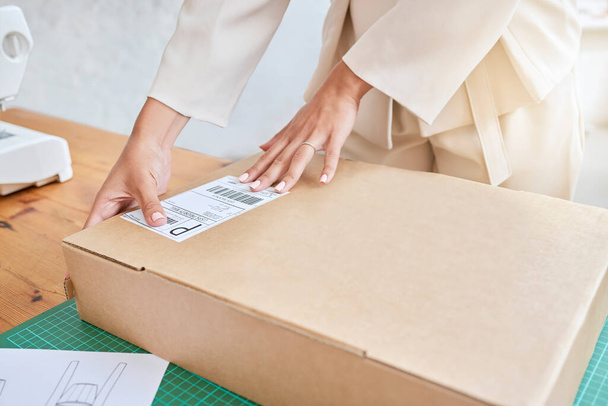Hands, logistics and box for shipping, delivery or package in ecommerce, purchase or inventory at workshop. Hand of business owner packaging item, object or label to deliver, service or sticker sign. - Foto, Imagen