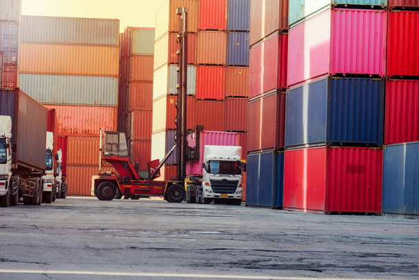 Carretillas elevadoras de contenedores y camiones en el patio de contenedores Enfoque en las importaciones y exportaciones - Foto, Imagen