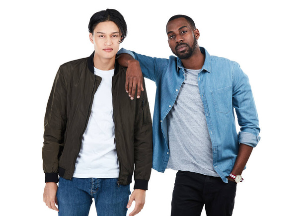 Two young men, studio portrait and friends at college for confidence, motivation or goals by white background. Isolated gen z students, black man and asian man with support, diversity and solidarity. - Fotografie, Obrázek