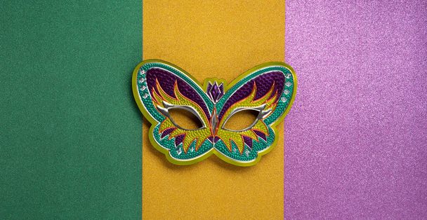 Mardi Gras masquerade festival carnival mask on green, golden, purple background. Holiday party invitation, greeting card concept. - Zdjęcie, obraz