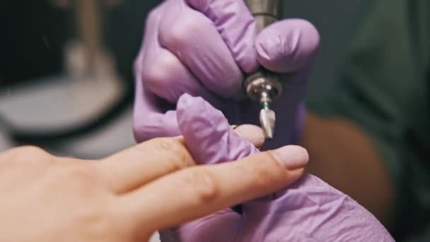 Close up footage of specialist removing gel nail polish from manicure with electrical drill machine. - Footage, Video