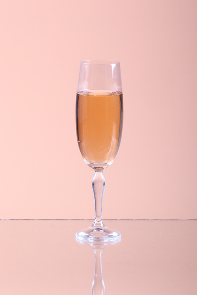 Glass of champagne on a beige background - Фото, зображення