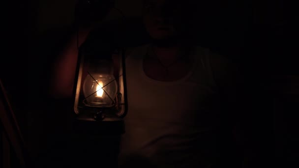An old kerosene lamp is a light in the dark. There is no electricity - Video
