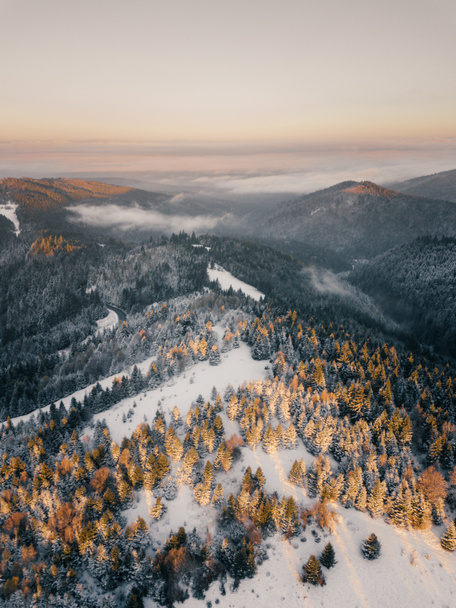Moody aerial drone idyllic winter landscape in sunrise. View from the top of the mountain. Hipster, vintage, abstract style  - Foto, immagini