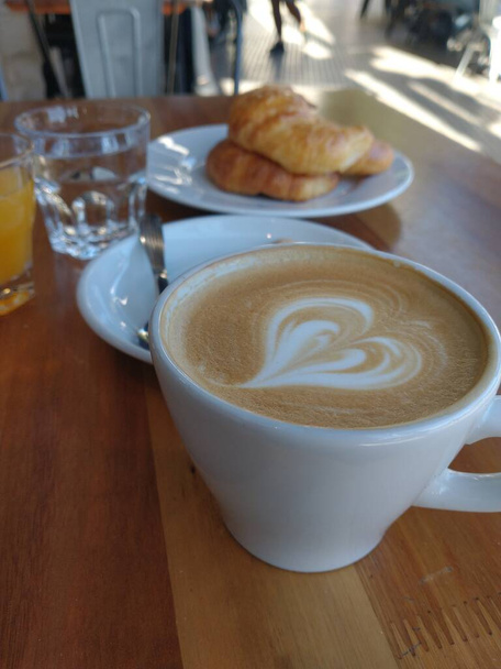 latte with heart-shaped diffuser, breakfast in a cafe - Photo, Image