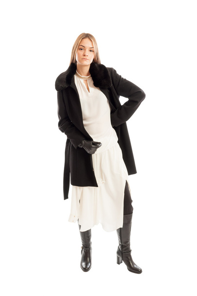 Female model wearing black wool coat on white dress - Фото, изображение