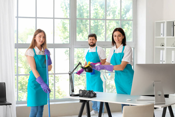 Young janitors cleaning in modern office - Photo, Image