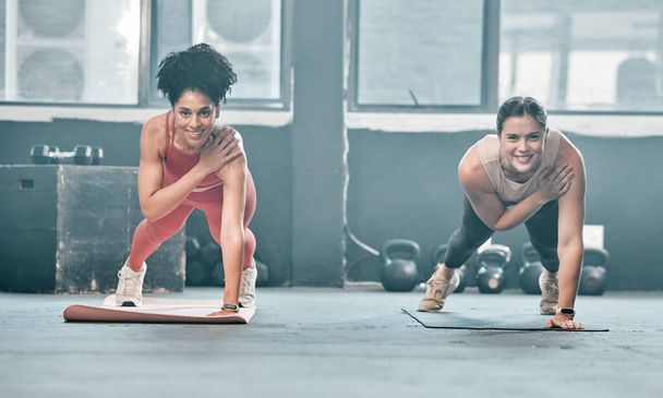 Woman, fitness and friends in class on mat for workout, exercise or training at the gym. Portrait of happy women with smile for healthy exercising balancing on arm for plank or cardio at gymnasium. - Foto, Imagem