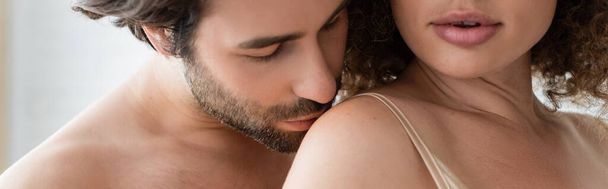 bearded and shirtless man kissing shoulder of sexy woman, banner  - Foto, immagini