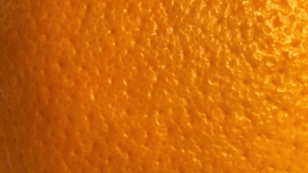 Shooting the texture of a ripe orange peel. Close up. Slow motion. - Video