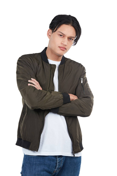 Confident, trendy and portrait of an Asian man with arms crossed isolated on a white background. Fashion, cool and edgy model posing with confidence, tough style and serious on a studio backdrop. - Φωτογραφία, εικόνα