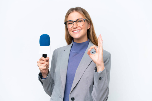 Young TV presenter caucasian woman isolated on white background showing ok sign with fingers - Fotó, kép