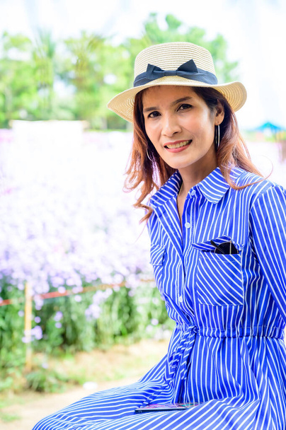 Thai Woman with Flower Garden Background at Chiang Mai Province, Thailand. - Photo, image