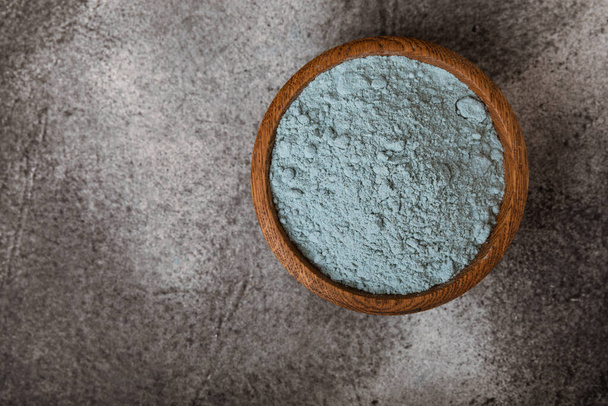 Blue Spirulina algae powder on black marble background. Diet and detox concept.Natural vegan superfood. Food supplement. Copy space. Place for text. - Zdjęcie, obraz
